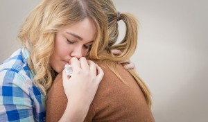 Mother embracing and soothes depressed daughter